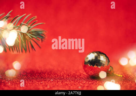 Yellow disco ball on red background close up. Stock Photo