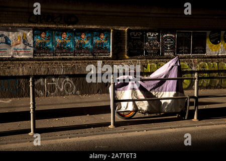 parked motorcycle covered with a tarpaulin stands on the street Gereonswall in the district Neustadt-Nord, Cologne, Germany.  ein geparktes Motorrad m Stock Photo