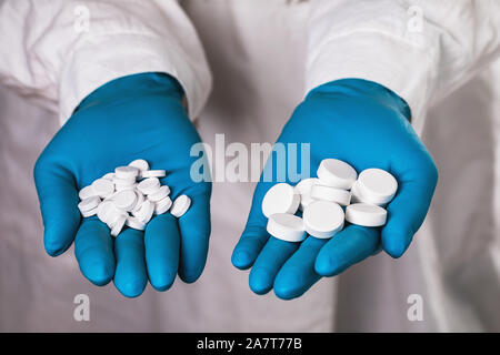 Various pills in the hands of a doctor close-up. The concept on the production of medicines Stock Photo