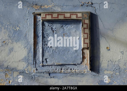 old mosaic type frame on distressed painted wall, kent, england Stock Photo