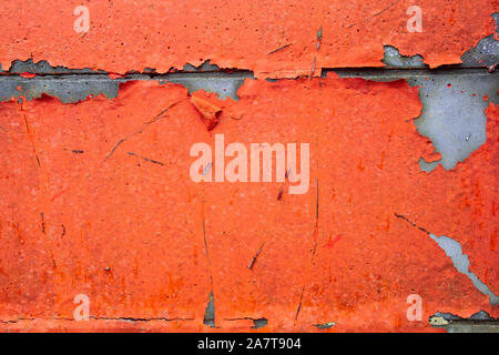 Grunge Concrete Wall Texture peeling paint, old cracked wall peach or pink colored Stock Photo