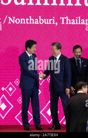 (191104) -- BANGKOK, Nov. 4, 2019 (Xinhua) -- Japanese Prime Minister Shinzo Abe (L) shake hands with South Korean President Moon Jae-in during a photo session of the 3rd Regional Comprehensive Economic Partnership (RCEP) Summit in Bangkok, Thailand, Nov. 4, 2019. (Xinhua/Zhu Wei) Stock Photo