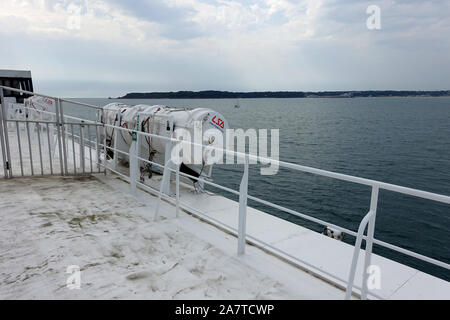 Jersey 25 July 2019: Lifeboat containers on the side of a condor ferry at sea near Jersey Stock Photo