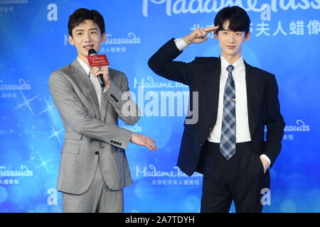 Chinese actor Bai Jingting, left, poses with a wax figure of him during an unveiling ceremony at the Madame Tussauds museum in Beijing, China, 20 Augu Stock Photo