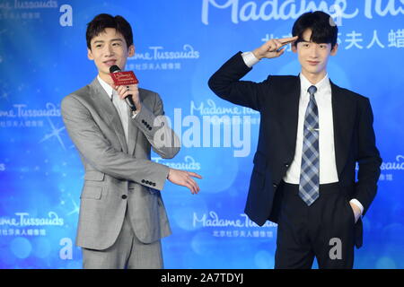 Chinese actor Bai Jingting, left, poses with a wax figure of him during an unveiling ceremony at the Madame Tussauds museum in Beijing, China, 20 Augu Stock Photo