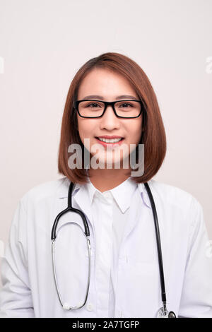 Portrait of an attractive young female asian doctor in white coat Stock Photo