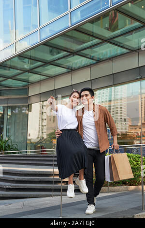 Young happy couple with shopping bags in the city,having fun together Stock Photo