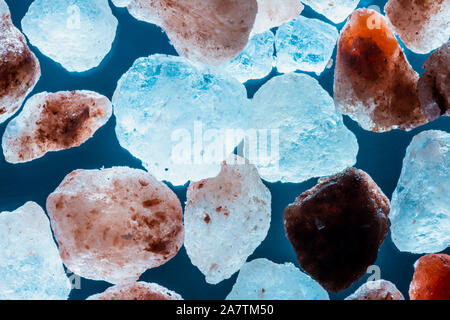 macro pink salt mineral stones on blue background Stock Photo