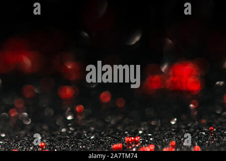 black and red abstract background with defocused glitter effect, shiny and festive bokeh image with copy space Stock Photo