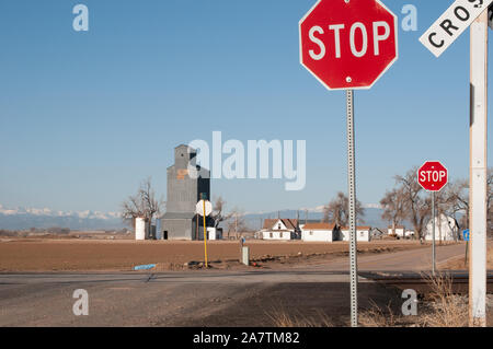 Dirt road with a railroad crossing controled with stop signs. Stock Photo