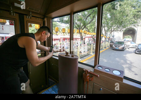 Passengers experience the old-fashioned bus in Xi’an city, northwest China’s Shaanxi province, 16 August 2019. An old-fashioned bus with green color, Stock Photo