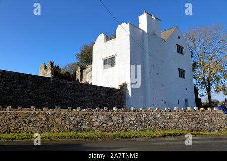 A ruined and now partially restored village castle showing life after many years of abandonment in a quiet village location in South Wales. Stock Photo