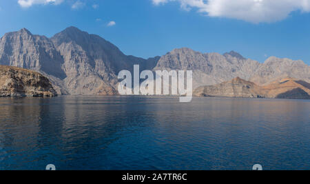 Spectacular panorama of the fjords and rocky mountains and blue waters of Khasab, Musandam, Oman in the Middle East near the Strait of Hormuz. Stock Photo