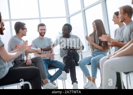group of young people greeted the speaker with their applause Stock Photo