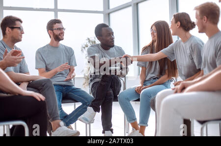 group of young people greeted the speaker with their applause Stock Photo