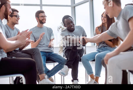 group of young people greeted the speaker with their applause Stock Photo