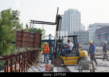 Construction workers are working on the Sihong Qingyang Bridge to be completed in Suqian city, east China's Jiangsu province, 25 August 2019. Stock Photo
