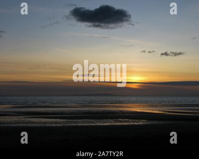 Sunset over the Isle of Man from Seascale, Cumbria, England, United Kingdom Stock Photo