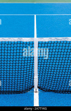 Detail of a Blue Tennis court with black net on Outdoor. Sport background Stock Photo