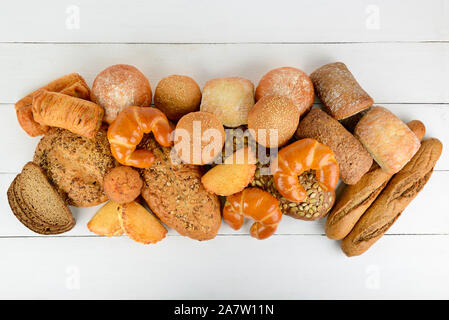 Bread, buns, croissants and other baked goods on wooden table. Top view. Copy space Stock Photo