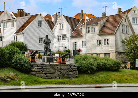 Statue of Vice Admiral Thore Horve with historic white wooden houses as background in Stavanger old town. Stock Photo