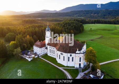 Wieskirche at sunrise, pilgrimage church to the Scourged Saviour on the Wies, Wies, near Steingaden, Pfaffenwinkel, aerial view, Upper Bavaria Stock Photo