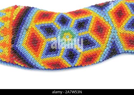 Close-up detail of bead-work on a beaded snake crafted by the Huichol indigenous peoples of Northern Mexico. Stock Photo