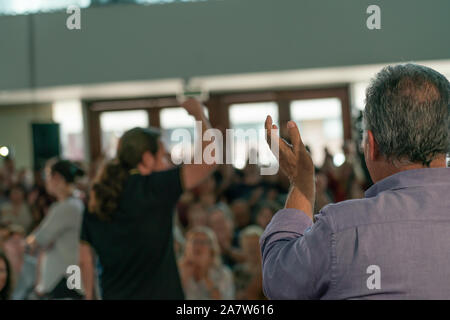 Palma de Mallorca, Spain / November 01, 2019: Clapping man in a political meeting of the leader of the political party Podemos, Pablo Iglesias. Stock Photo