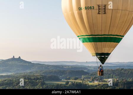 Hot air balloon over the Czech Paradise. In the background Trosky Castle. Stock Photo