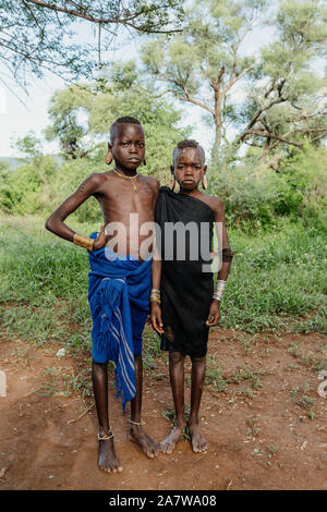 ETHIOPIA, OMO VALLEY, MAY 6: Young boys of wildest and most dangerous African Mursi people tribe living according to original traditions in Omo valley Stock Photo