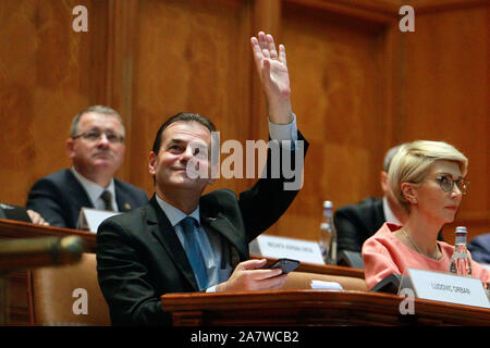 (191104) -- BUCHAREST, Nov. 4, 2019 (Xinhua) -- Ludovic Orban (L, Front), leader of the Romanian National Liberal Party, gestures during a parliament session in Bucharest, capital of Romania, on Nov. 4, 2019. The Romanian National Liberal government won a vote of confidence in parliament on Monday, replacing the Social Democrats who had been in power for nearly three years. (Photo by Cristian Cristel/Xinhua) Stock Photo