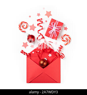 Open Christmas surprise gift red envelope letter mail exploding red items on a white background. Stock Photo