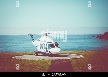 Atlantic Airways helicopter landing on the remote island of Mykines. Stock Photo