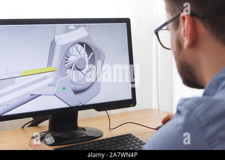 Engineer, Constructor, Designer in Glasses Working on a Personal Computer. He is Creating, Designing a New 3D Model of Helicopter in CAD Program. Free Stock Photo