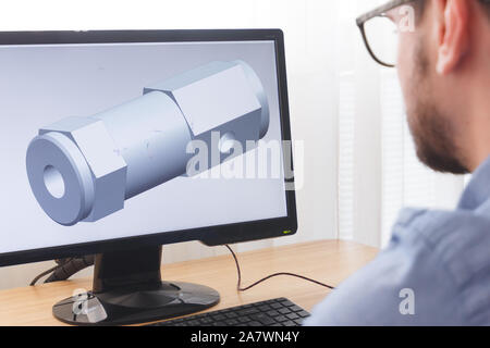Engineer, Constructor, Designer in Glasses Working on a Personal Computer. He is Creating, Designing a New 3D Model of Mechanical Component in CAD Pro Stock Photo
