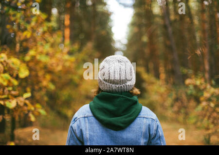 Back view of unrecognizable woman  in forest. Stock Photo
