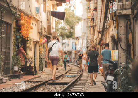 Tourists walk down the famous and beautiful Train Street in North Vietnam before it was closed down to the public due to accidents Stock Photo