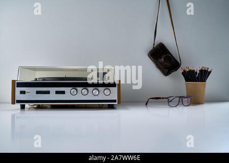 Composition with retro stereo radio and other vintage things with a gentle bouquet of flowers on a light gray background Stock Photo