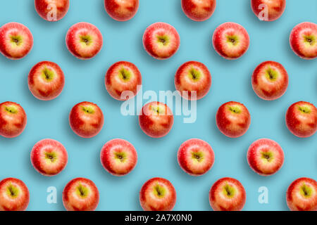 Modern creative healthy snack food concept Pattern of apples on bright colourful blue background in minimalist style Stock Photo