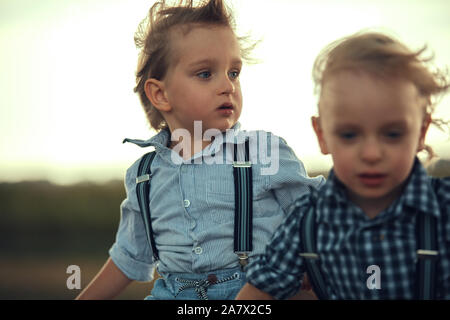 Two adorable brothers having fun in the countryside Stock Photo