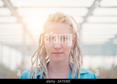 Young urban woman with blond dreadlocks hair portrait Stock Photo