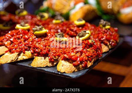 Red pepper pintxos with olives at Atari Gastroteka tapas bar in the old town of San Sebastian, Spain Stock Photo