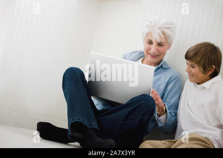 Grandmother using laptop with grandson Stock Photo