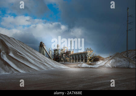 Rock and stone piles at a local road construction company in the winter. Ludington, Michigan, USA. Stock Photo