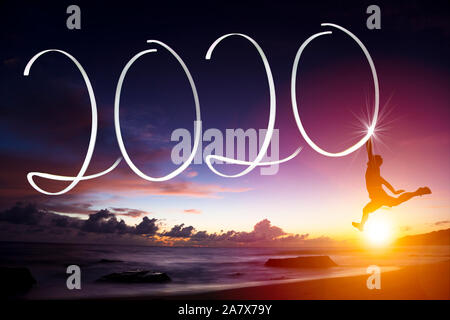 young man jumping on the beach. happy new year 2020 concepts Stock Photo
