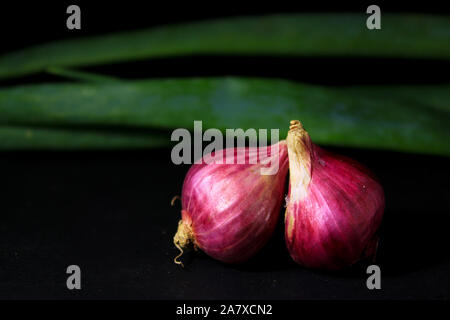 Red onions isolated on black background. Stock Photo