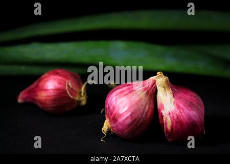 Red onions isolated on black background. Stock Photo