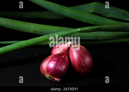 Red onions isolated on black background. Stock Photo