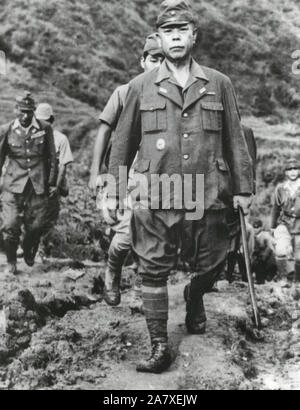 General Yamashita, Commander, Japanese forces, ‘Tiger of Malaya,” and his staff walk down the trail to U.S. forces in northern Luzon, occupied by Co ‘I’, 128th Inf Regt, 32nd Division. September 2, 1945 Stock Photo