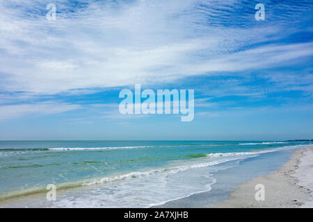 Waves lapping on a sandy beach on a beautiful summer day Stock Photo